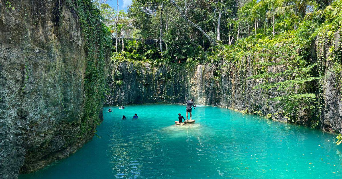 Cenote Atik — open-air sinkhole with turquoise water and limestone walls